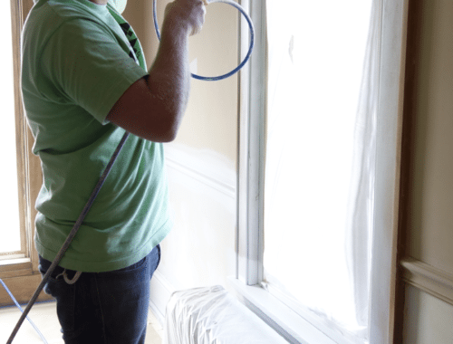 spraying-primer-on-bedroom-trim